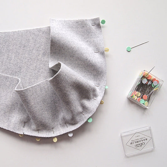 Gray wool coating pinned with colorful flower-head pins showing curved hood seam construction for Cascade Duffle Coat