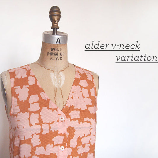 Alder Shirtdress v-neck variation in coral and pink geometric print on dress form with alder v-neck variation text overlay