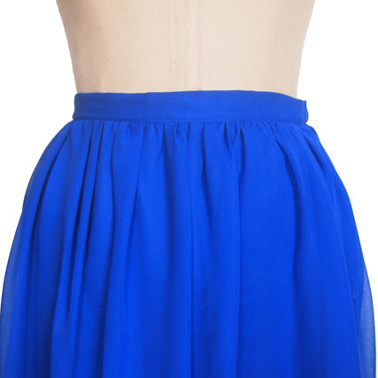 Cobalt blue gathered chiffon skirt with a straight waistband displayed on a dress form, showing free-hanging overlay technique
