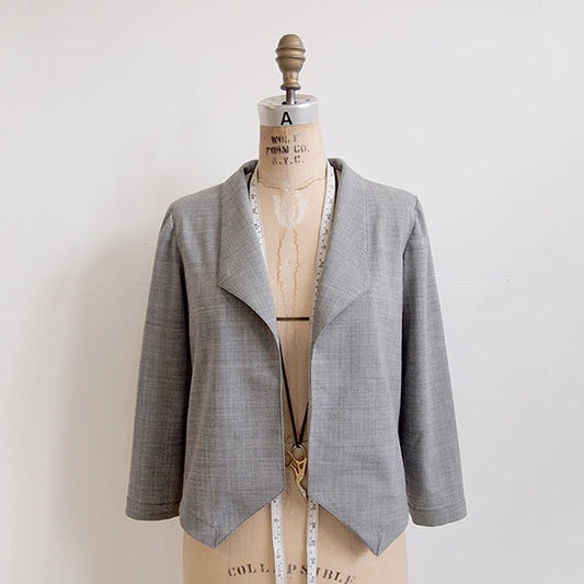 Morris Blazer in gray wool on dress form with measuring tape, showing open front drape and completed sleeve facing construction