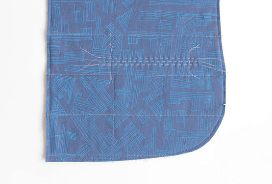 Tamarack Jacket fabric with welt pocket markings and hand basting lines in blue geometric print
