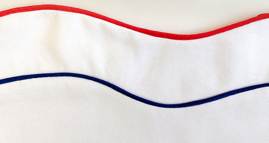 Wavy red and navy piping sewn into white sweatshirting, demonstrating piping application technique