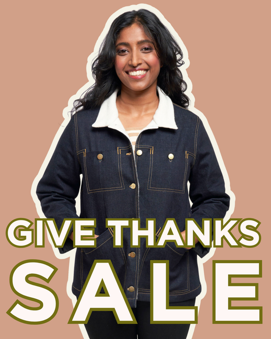 Give Thanks Sale — model wearing Thayer Jacket in dark denim with sherpa collar, gold buttons, and contrast stitching