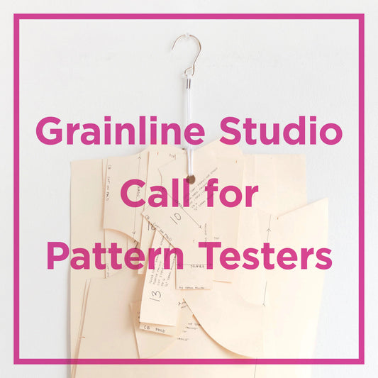 Grainline Studio Call for Pattern Testers graphic with oaktag sewing pattern pieces on a pattern hook and magenta text overlay