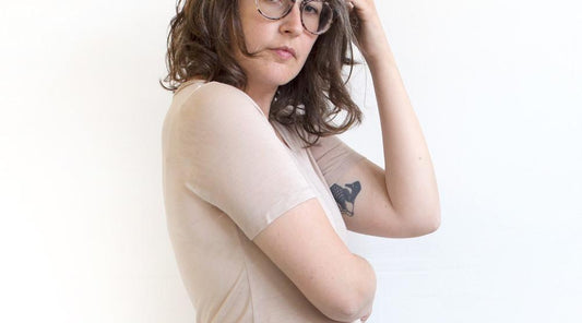 Person wearing a blush Lark Tee with short sleeves against a white background, showing the fitted silhouette