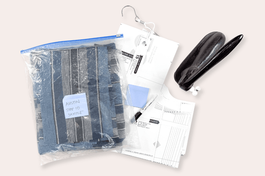 Cut Austin Dress sample in blue striped linen and pattern pieces in labeled zip-lock bag for work-in-progress organization