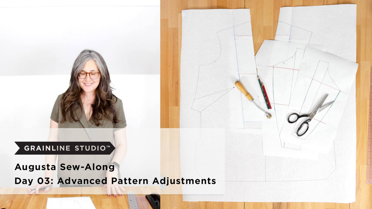 Woman smiling at a table beside traced Augusta pattern pieces with a tracing wheel, colored pencils, and fabric shears