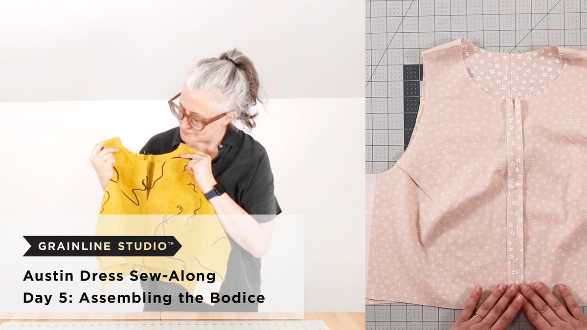 Jen examining a yellow linen Austin Dress bodice next to a flat lay of an assembled blush bodice with center front seam on a cutting mat