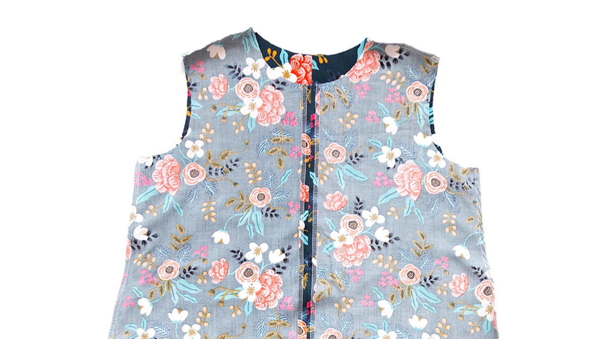 Blue floral Farrow Dress bodice showing completed shoulder and side seams with serged edges joining front and back pieces together.
