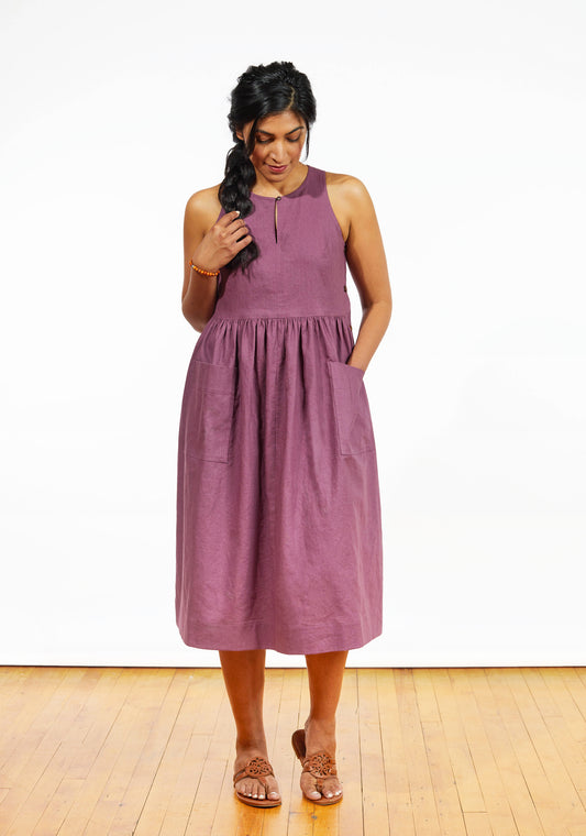 Model: Size 8, 5'9" | Back view of Austin Dress in orange stripe cotton with fitted bodice and flared skirt, worn by model.