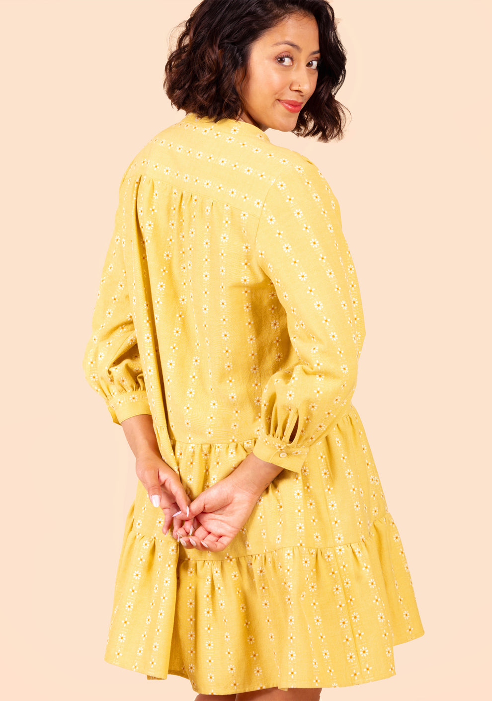 Close-up back of Poppy Dress View B highlighting yoke, gathers, and daisy pattern on yellow fabric.
