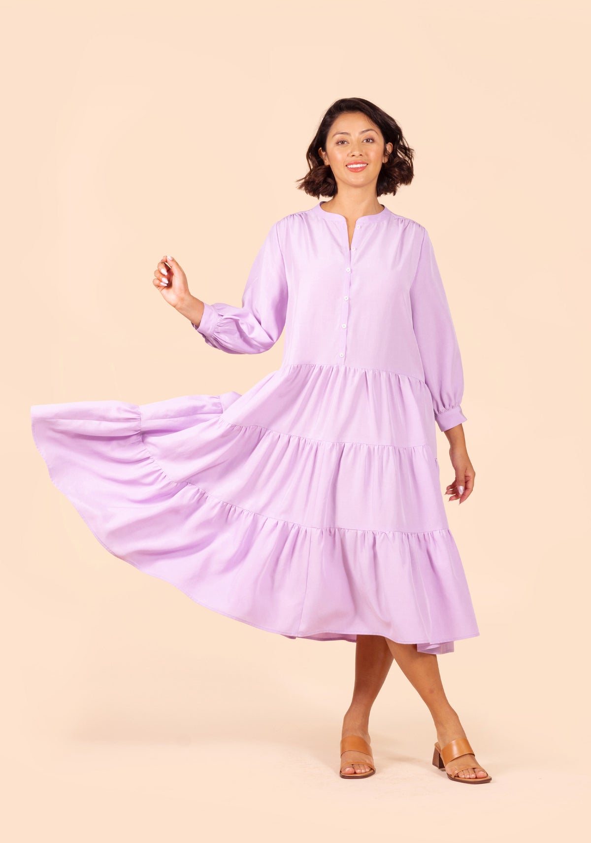 Front view of Poppy Dress View D in lilac, showing tiered skirt in motion.