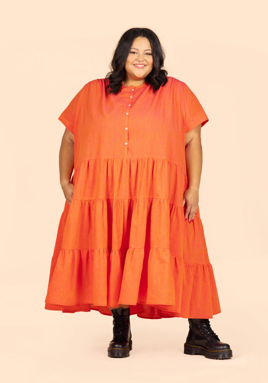 Model: Size 32, 5'3" | Standing front view of long Poppy Dress View B with short sleeves, button placket, and gathered skirt.