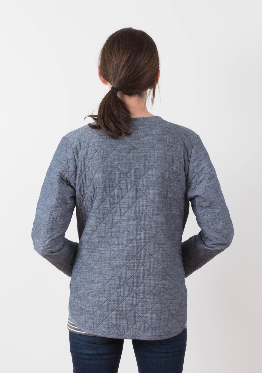 Back view of blue diamond quilted Tamarack Jacket in View A showing shaping and hem curve.