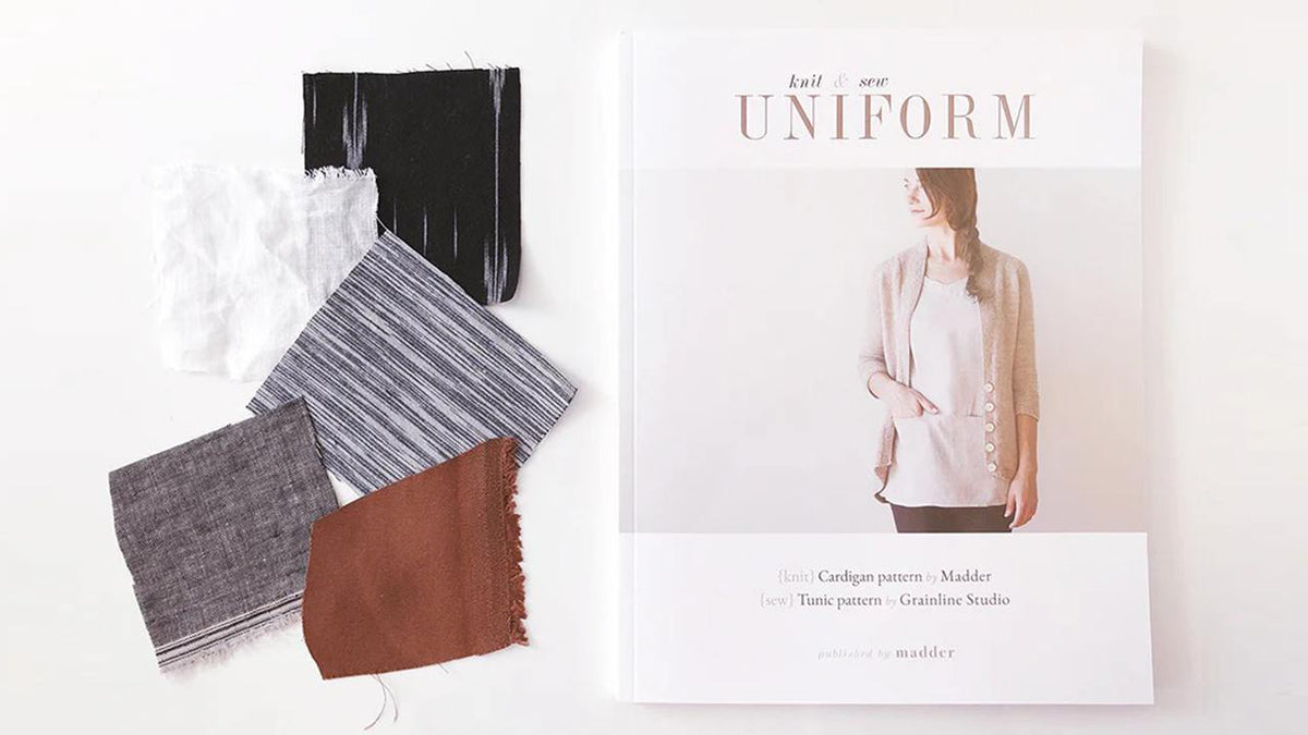 Uniform Knit & Sew book with fabric swatches in black, white striped, gray, and rust colors for Uniform Tunic pattern.