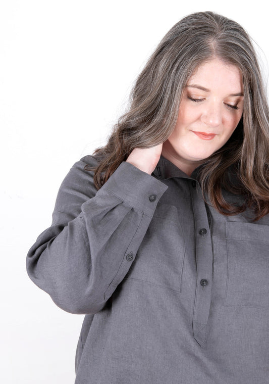 Model: Size 20, 5'5" | Model wearing Archer Popover shirt in charcoal, front view with hand at neck.