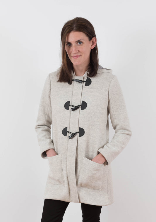 Model: Size 6, 5'8" | Front view of long Cascade Duffle Coat in heathered gray wool with toggle closures and front patch pockets.