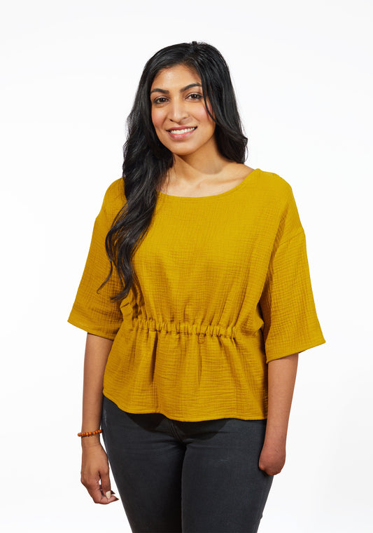 Model: Size 8, 5'9" | Front view of Corin Top in mustard double gauze with gathered waist and elbow-length sleeves.