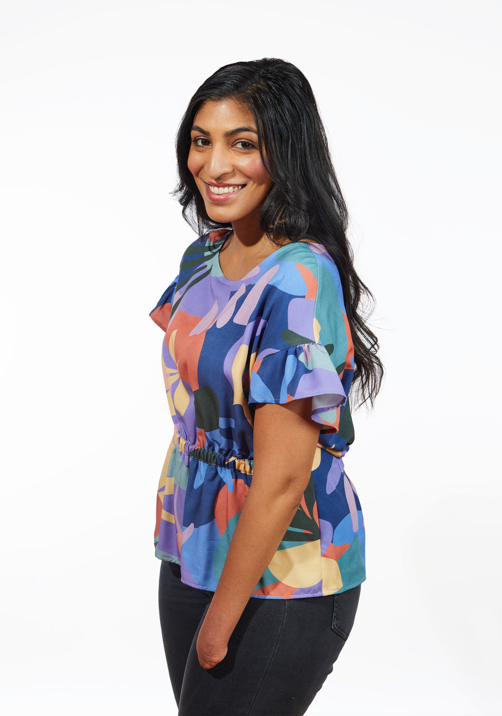 Side view of Corin Top showing short flutter sleeve and gathered waist detail.