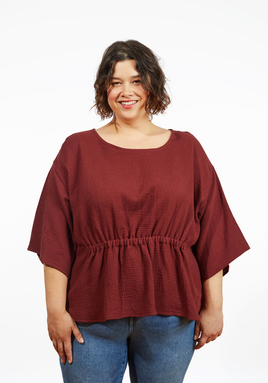Front view of Corin Top in brick double gauze with wide sleeve and elastic waist, worn by model.