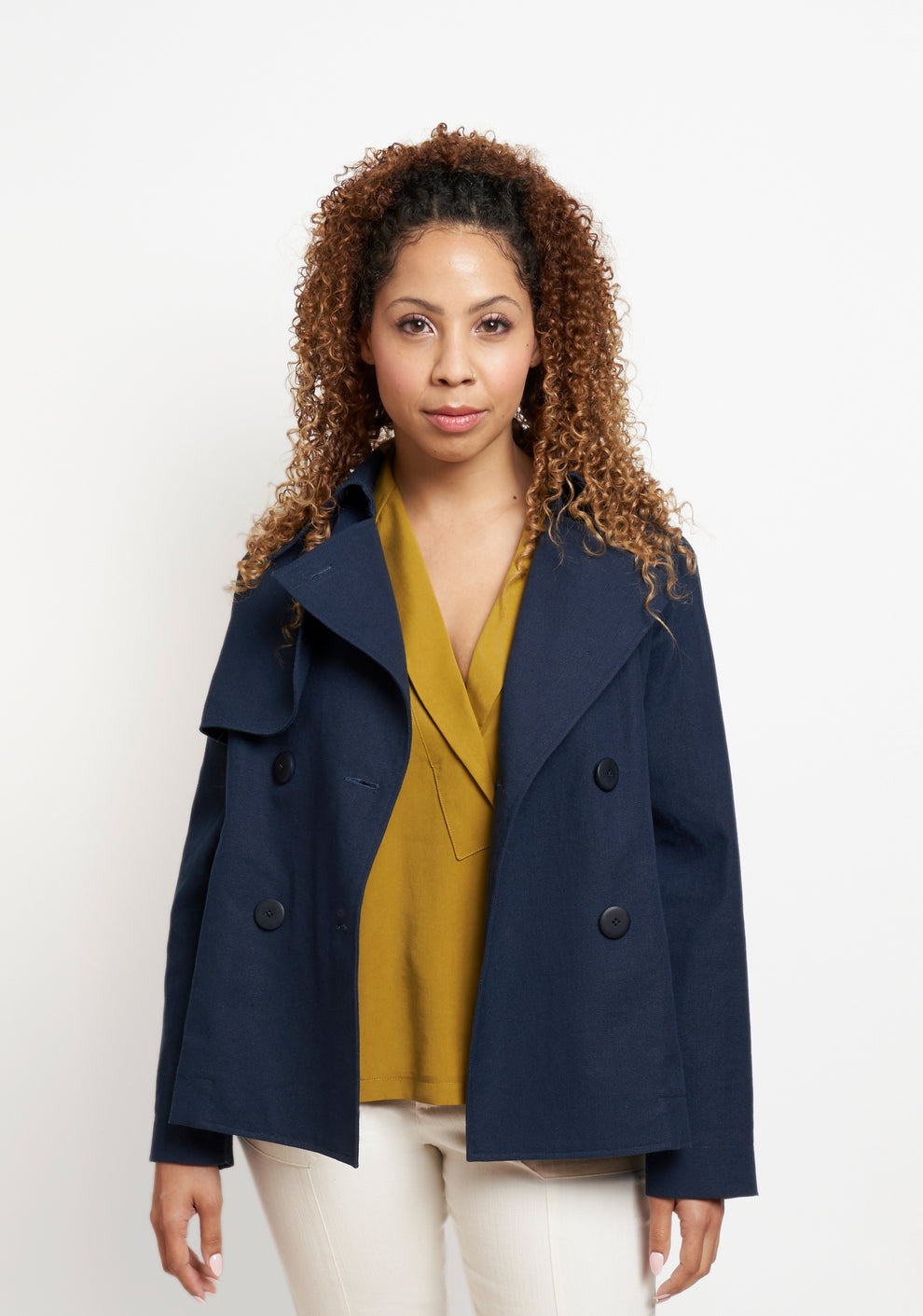 Front view of Cortland Trench View A with collar open, worn over a Augusta Top and cream pants.