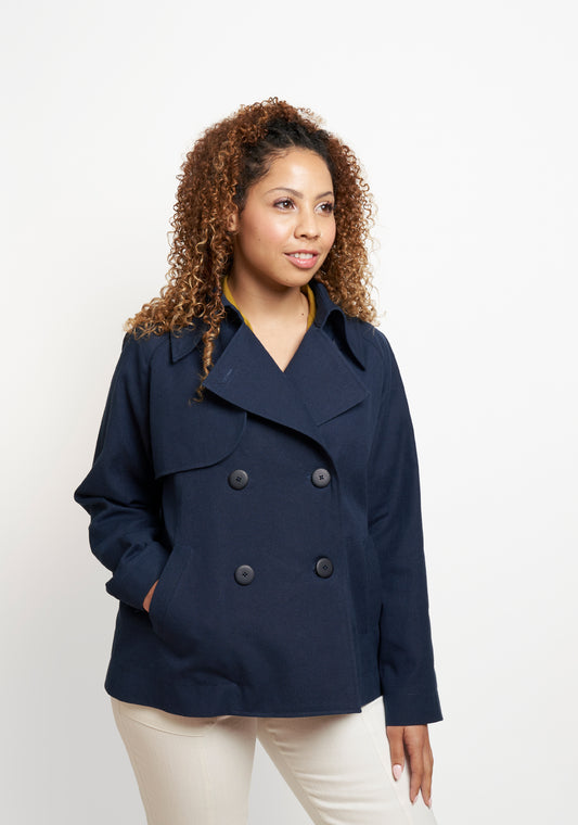 Model: Size 8, 5'5" | Cortland Trench View A front view with model's hands in pockets, highlighting collar and topstitching.