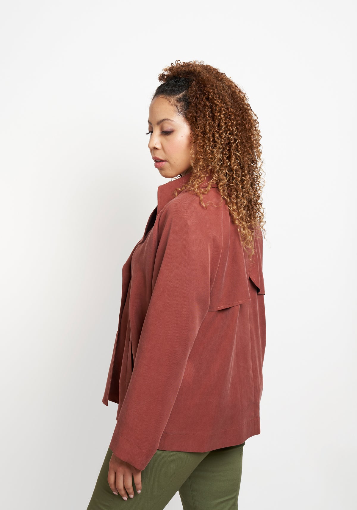 Side angled view of Cortland Trench View B highlighting drape and shoulder detail.