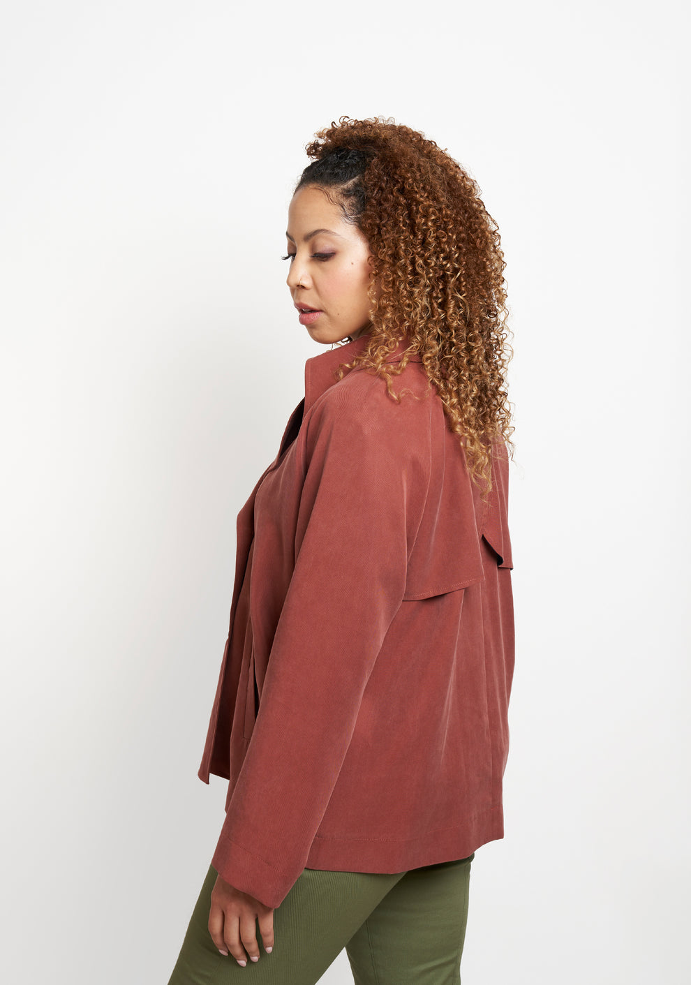 Side angled view of Cortland Trench View B highlighting drape and shoulder detail.