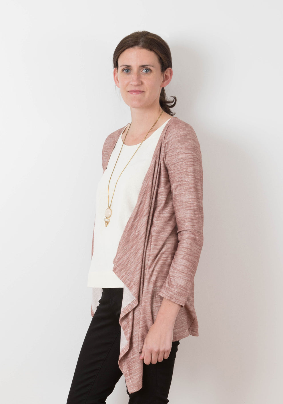 Side view of the rose Lark Cardigan on model, displaying its open front and flowing drape.