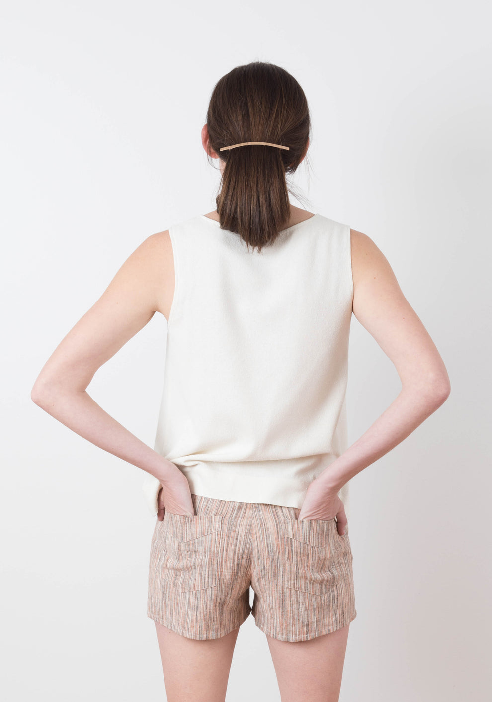 Back view of model in striped Grainline Maritime Shorts showing patch pockets.