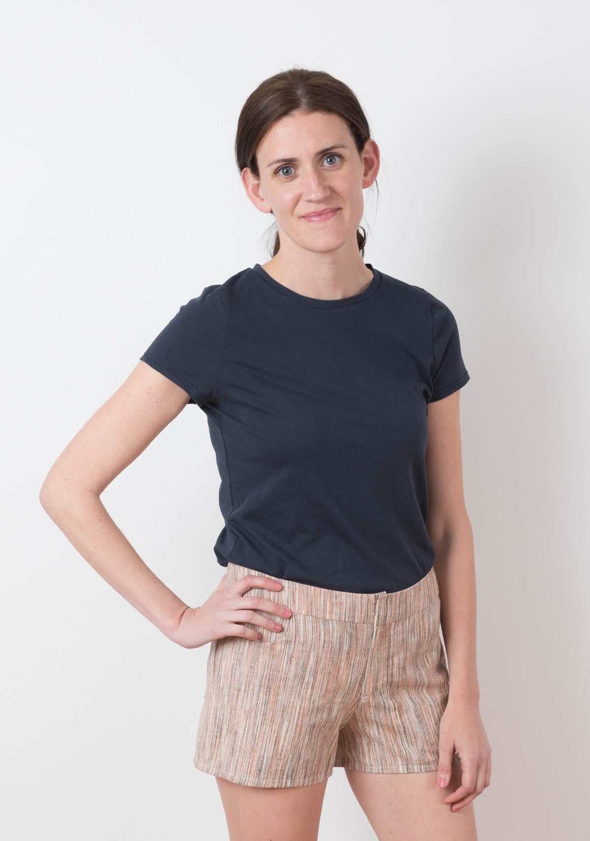 Model: Size 6, 5'8" | Model wearing striped Grainline Maritime Shorts with a navy tee, standing with hand on hip.