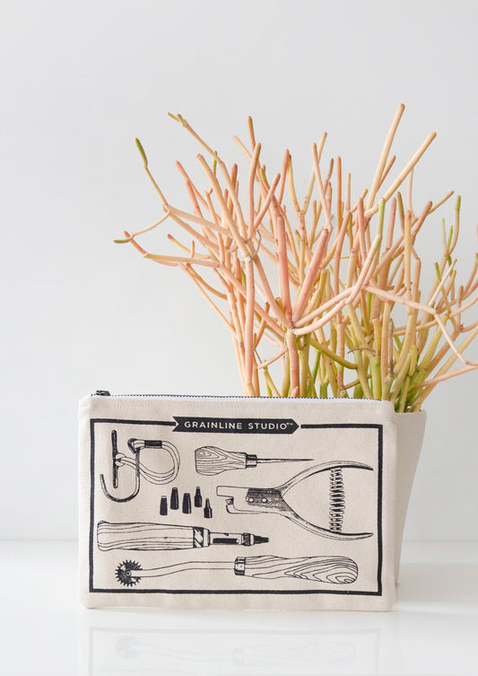 Grainline Studio Pattern Tools pouch standing upright in front of a pencil cactus.
