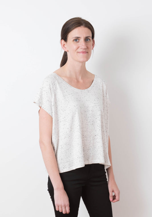 Model: Size 6, 5'8" | Angled front view of model in Penny tee showing relaxed fit and drape of short sleeve knit design.