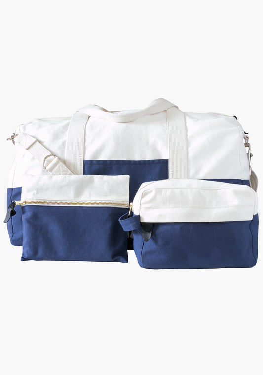 Portside Travel Set shown with dopp kit and zip pouch attached to duffle bag, all in blue and natural canvas.