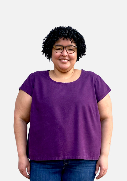 Model: Size 24, 5'5" | Model wearing a short-sleeved purple Scout Tee with a scoop neckline and relaxed fit, shown from the front.