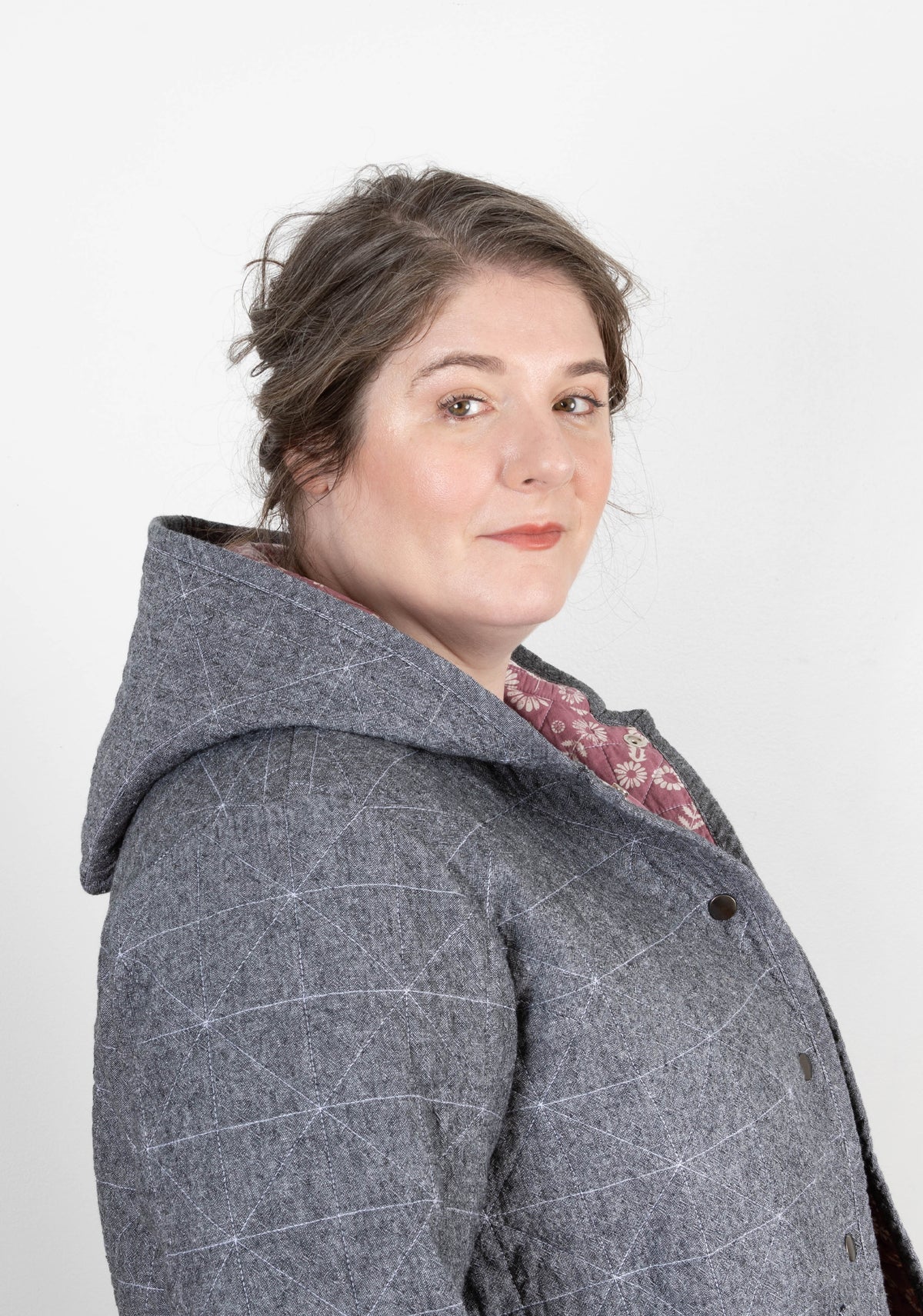 Side detail of gray Tamarack Jacket with hood add-on, floral lining peeking out.
