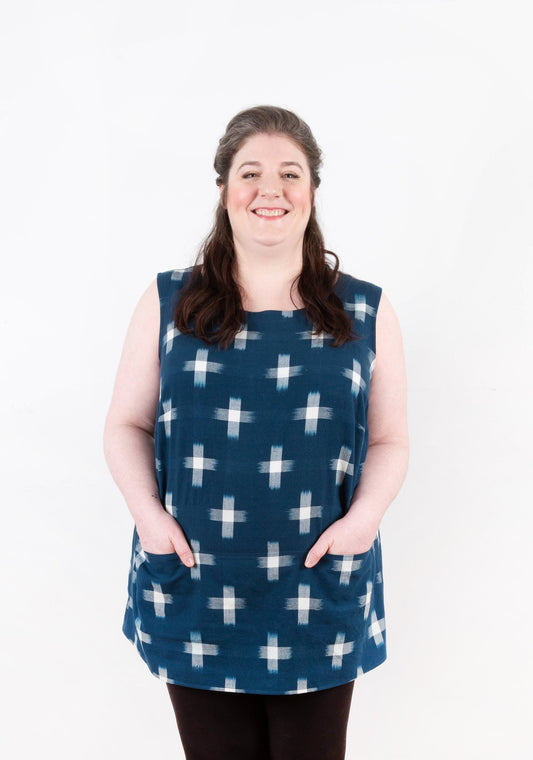 Model: Size 20, 5'5" | Front view of sleeveless Uniform Tunic in navy ikat print with patch pockets.