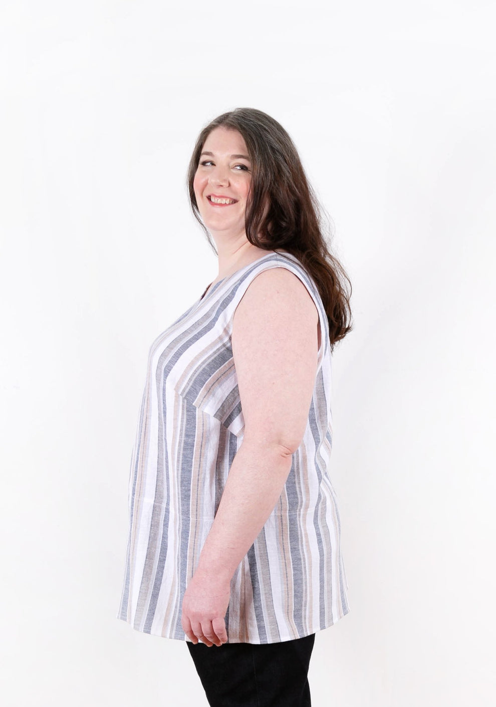 Side view of striped sleeveless Uniform Tunic with curved hem and gentle A-line shape.