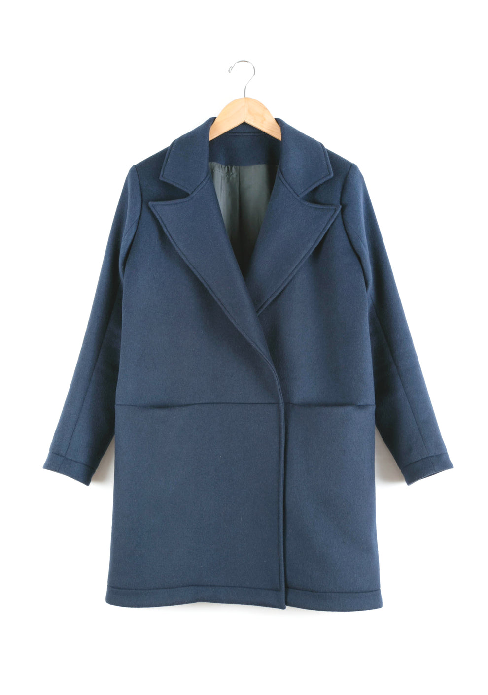Flatlay of Yates Coat on hanger showing front design with wide lapels and clean finish.
