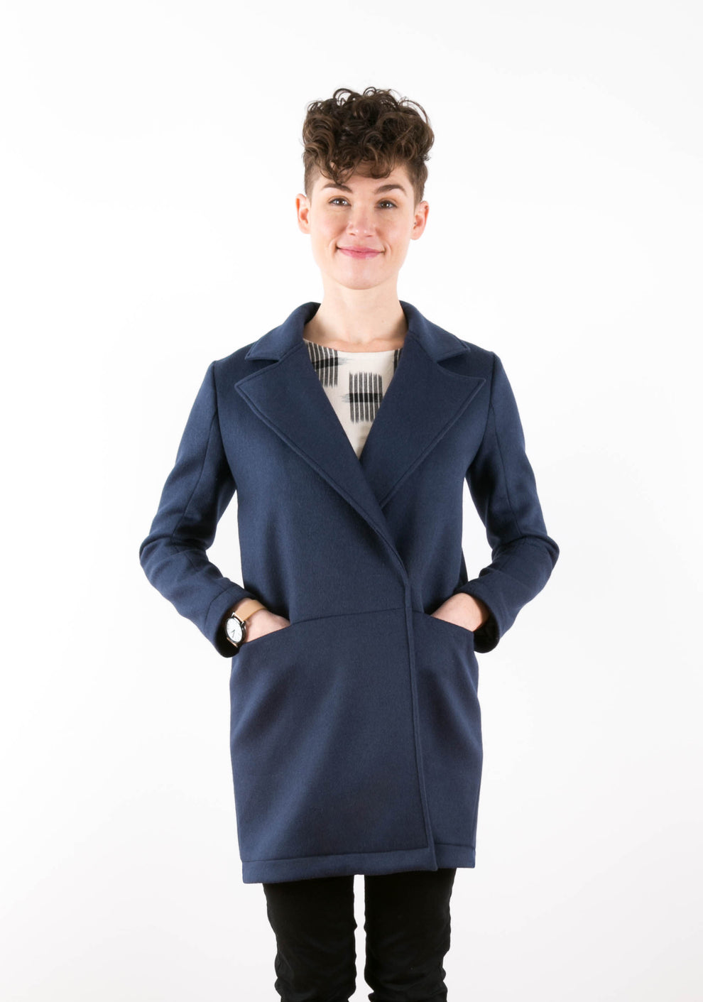 Straight-on front view of Yates Coat closed at front with model‚Äôs hands in pockets.